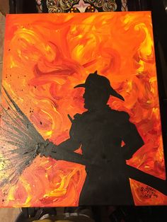 the silhouette of a firefighter is painted on an orange and black background with flames