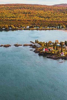 an aerial view of a small island surrounded by trees