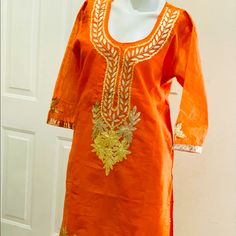 Orange Color Sharara Set With Gotta Patti Work. Size 42, Chanderi Silk Fabric With Cotton Lining. 3 Piece Includes Kurti Sharara And Stoll Dupatta. New Without Tag Orange Bollywood Kurta With Mirror Work, Bollywood Style Orange Kurta With Mirror Work, Fitted Orange Kurta With Zari Work, Summer Party Kurta With Gota Work, Fitted Orange Cotton Traditional Wear, Orange Traditional Wear For Festivals And Parties, Fitted Orange Sets With Mirror Work, Party Orange Kurta With Zari Work, Orange Cotton Bollywood Traditional Wear