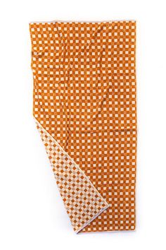 an orange and white checkered cloth with two squares on the front, one is folded up