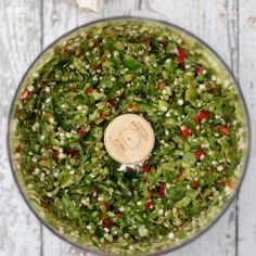 an overhead view of a food processor filled with chopped green peppers and red bell peppers