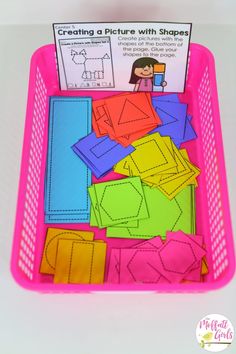 a pink basket filled with lots of cut out shapes for kids to use in crafts