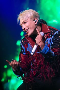 a male in a red and blue outfit holding a microphone