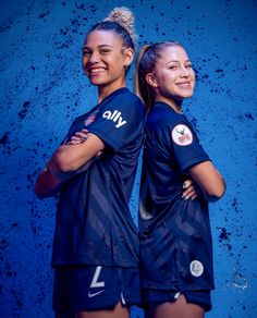 two female soccer players are posing for a photo