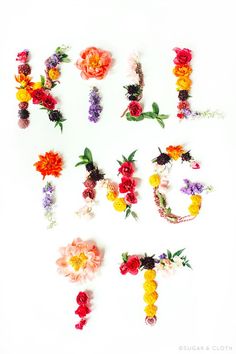 the word love spelled with flowers on a white background