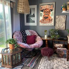 a living room filled with lots of furniture and pictures on the wall next to a window