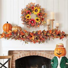 a fireplace mantel decorated with pumpkins, sunflowers and other autumn decorations