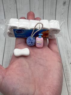 a person holding out their hand with several items in it