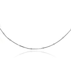 This unique choker necklace features an Italian box chain with small station beads. This dainty choker is 13" plus a 3" extender. It is crafted of fine sterling silver and secures with a spring ring clasp. Product Details Metal Type sterling-silver Metal Stamp 925-sterling Weight 2.3GR Length 13IN Width 1MM Clasp Type spring-ring Chain Type box Chain Length 13 Classic Adjustable Delicate Chain Necklace, Minimalist White Gold Chain Necklace With Adjustable Chain, Minimalist White Gold Necklace With Satellite Chain, Minimalist White Gold Satellite Chain Necklace, Silver Box Chain Fine Jewelry Necklace, Minimalist Adjustable Box Chain Necklace, Silver Metal Choker With Adjustable Chain, Minimalist Sterling Silver Choker With Adjustable Chain, Black Sterling Silver Box Chain Necklace