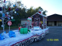 an outdoor display with gingerbread houses, candy canes and other decorations on it