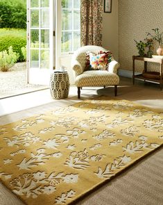 a living room filled with furniture and a yellow rug