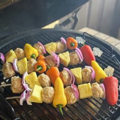 meat and vegetable kabobs are being cooked on the grill