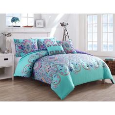 a bed in a room with blue and pink comforters