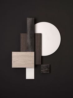 a black and white wall with some wood pieces on it