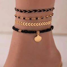 Fashionable 4 Piece Black Gold Toned Anklet Set. The First Anklet Is A Black Rope With Gold Toned Ball Chain Intwined Throughout. The Second Anklet Is A Gold Toned Textured Chevron Design. The Third Anklet Is A Gold Toned Anklet With Black Crystals. The Fourth Anklet Is A Black Beaded Anklet With A Gold Toned Dangle Seashell. Wear Them Together Or Separately To Change Your Look. The Rope Anklet Is Approx. 8.5” With A 2” Extension The Chevron Anklet Is Approx. 8.5” With A 2” Extension The Crystal Black Bohemian Anklets For Party, Bohemian Black Anklets For Party, Black Anklets For Summer Vacation, Black Summer Vacation Anklets, Elegant Beaded Bracelets For Vacation, Anklets Aesthetic, Layered Anklets, Rope Anklet, Black Anklet