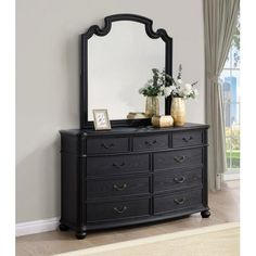 a black dresser and mirror in a room