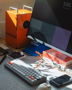 a computer monitor sitting on top of a desk next to a keyboard and mouse pad