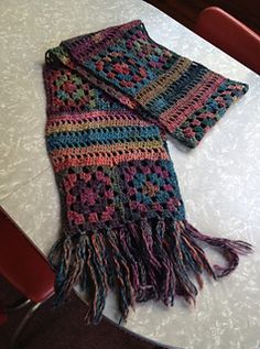 a multicolored scarf laying on top of a table