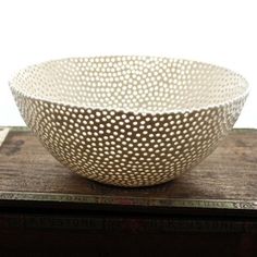 a white bowl sitting on top of a wooden table