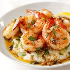 a white bowl filled with shrimp and grits