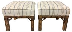 a pair of wooden stools with striped upholstered seats on each one side