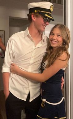 a young man and woman are dressed up in sailor outfits, posing for the camera