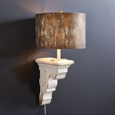 a lamp that is on top of a wall