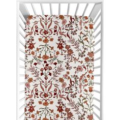 a white crib with red flowers and leaves on it's side, in front of a white background