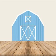 a blue barn with a white door and window on top of wooden floor in front of it