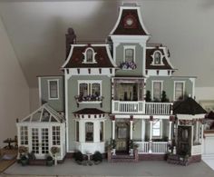 a large doll house with lots of windows and balconies on top of it