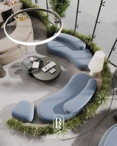 a living room filled with blue couches next to a white table and chair on top of a tile floor