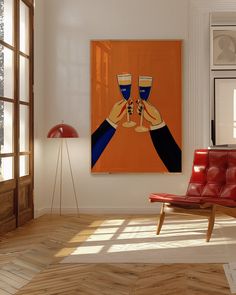 a red chair sitting in front of a painting on the wall next to a window