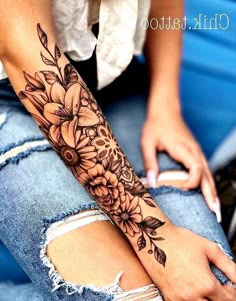 a woman's arm with flowers on it