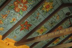 the ceiling is painted with colorful flowers and words