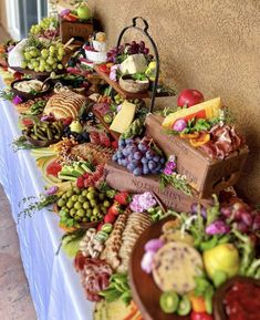 a long table filled with lots of different types of food on top of each other