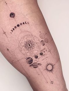 a tattoo on the leg of a person with planets and stars around it, all in black ink