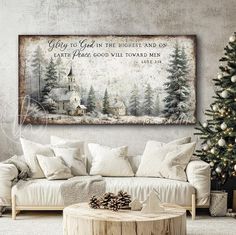 a living room with a christmas tree in the corner and a large painting on the wall