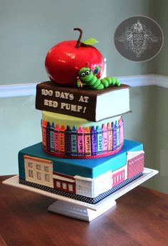 a cake made to look like books and an apple sitting on top of each other