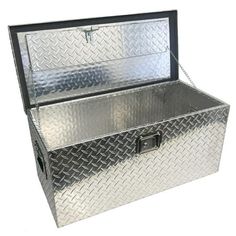 a metal tool box sitting on top of a white surface with chains hanging from it's sides