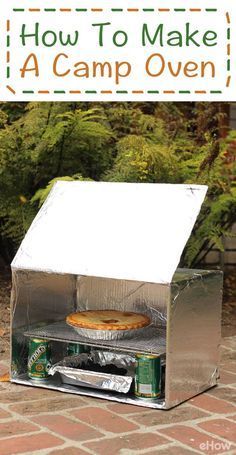 an open box with a pie in it sitting on top of a brick floor next to trees