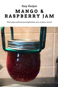 a mason jar filled with raspberry jam sitting on top of a kitchen sink