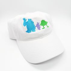 a white baseball cap with blue, green and purple bears on it's side