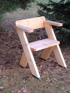 a wooden step stool sitting in the grass