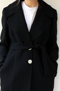 Absolutely gorgeous vintage 90s Dolce & Gabbana wool coat in black Super classy, three round front silver buttons and three on each arm sleeve marked D&G, side pockets, belt attached, fully Lined in black satin. aside from minor signs of wear Excellent vintage condition.Marked D&G Made in Italy.** Model is 5'7" and size S **  / bust: 33" / waist: 26" / hips: 37"Tag size: 46Approximate size S/M please refer to the MeasurementsMeasurements: taken while lying flat, double where necessar Formal Spring Wool Coat With Buttons, Elegant Wool Coat With Buttons, Chic Fitted Wool Coat With Button Cuffs, Elegant Outerwear With Covered Buttons, Elegant Fitted Wool Coat With Button Cuffs, Elegant Winter Pea Coat With Button-up, Elegant Button-up Pea Coat For Winter, Elegant Fitted Pea Coat With Button Cuffs, Elegant Black Pea Coat For Spring