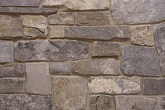 a stone wall that is made out of various types of stones