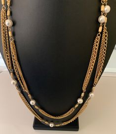 This pretty shiny three layer gold chain necklace is super long and can be worn doubled  for a short necklace.  It has white lucite faux pearl pearl accent beads.  The necklace is 57 inches long.  This is in great like new condition. I specialize in finding fun wearable jewelry please browse my shop for more options. I box all jewelry sales ready to be given as gifts. Gold Long Necklace With Pearl Chain For Formal Events, Gold Long Necklace With Pearl Chain For Formal Occasions, Gold Pearl Long Necklace For Formal Occasions, Multi-strand Layered Pearl Chain Necklace For Parties, Multi-strand Layered Pearl Necklace For Party, Pearl Multi-strand Necklace For Parties, Gold Pearl Beaded Chain Layered Necklace, Gold Pearl Layered Necklace With Beaded Chain, Gold Multi-strand Pearl Necklace