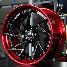 a red wheel with black spokes is on display