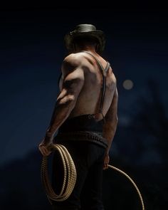 a man with no shirt holding a rope and wearing a hat on top of his head