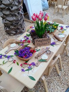 the table is set with flowers and knick knacks on it's sides