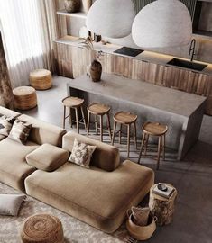 a living room filled with lots of furniture next to a counter top and bar area